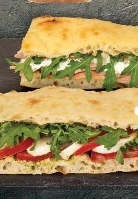 Sandwich with pesto, mozzarella, tomatoes and arugula